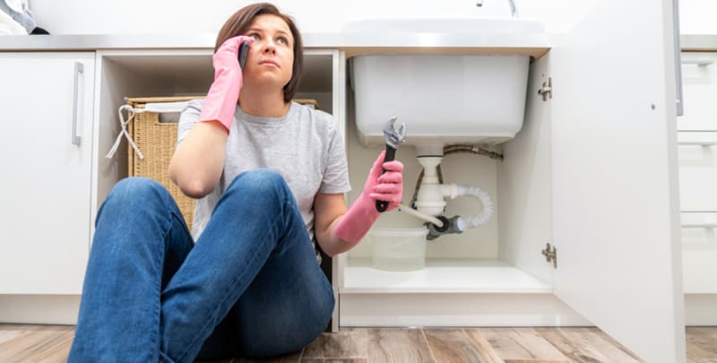 A woman has problems with DIY plumbing