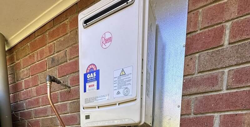 Rheem continuous flow system on outside wall